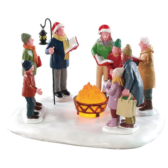 Toasty Caroling Lemax set decorativo natalizio con personaggi cantanti attorno al fuoco per villaggio di Natale - DeMatteis.it