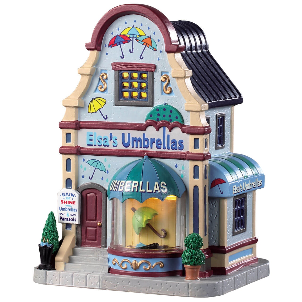 Elsa's Umbrellas Lemax negozio ombrelli villaggio miniatura con architettura vittoriana colorata, tetto nero e decorazioni dipinte a mano | Dematteis.it