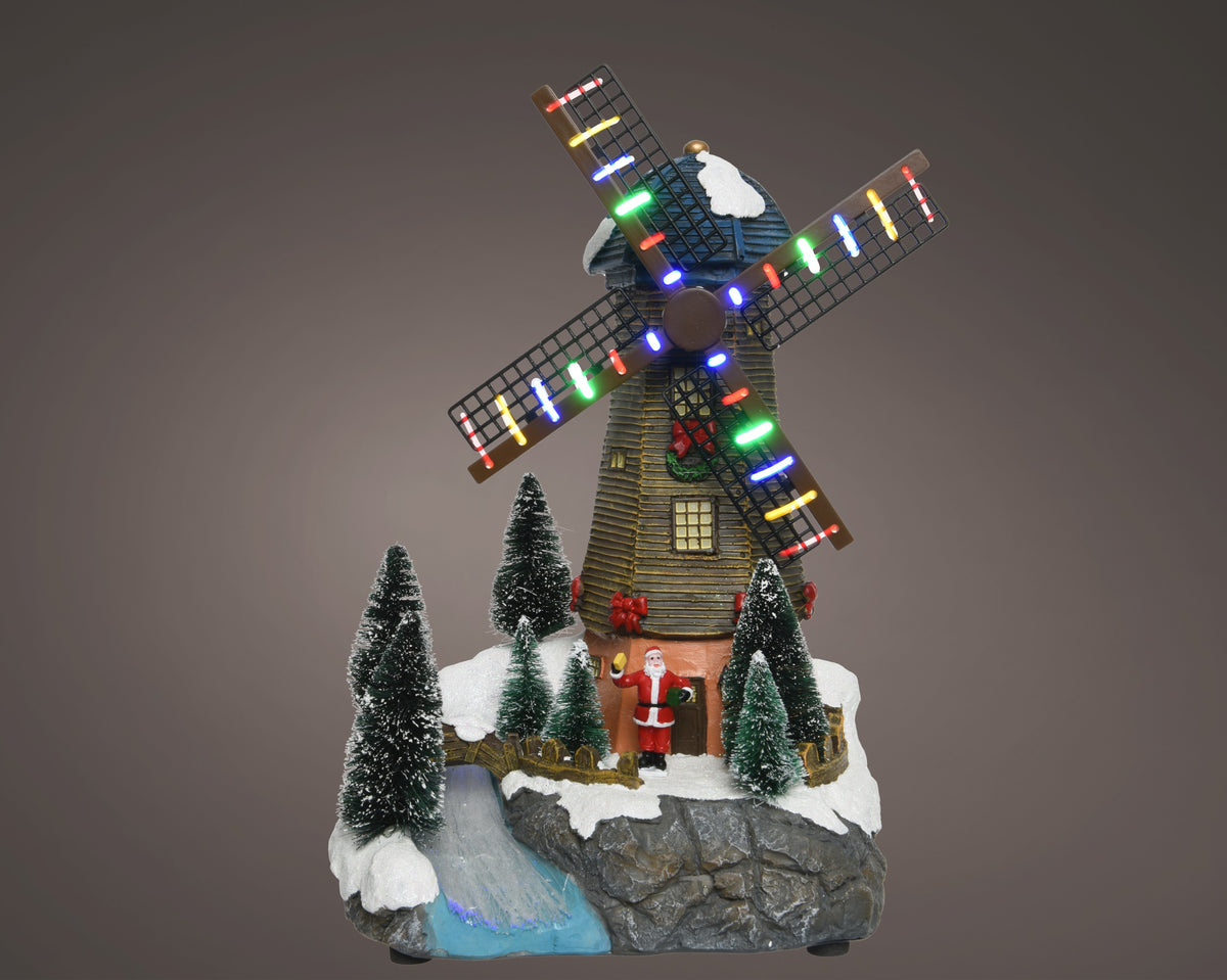 Kaemingk, Mulino a vento led con Babbo Natale, ambientazione natalizia Lemax con pale luminose multicolore, alberelli innevati e base in resina con ruscello - DeMatteis.it