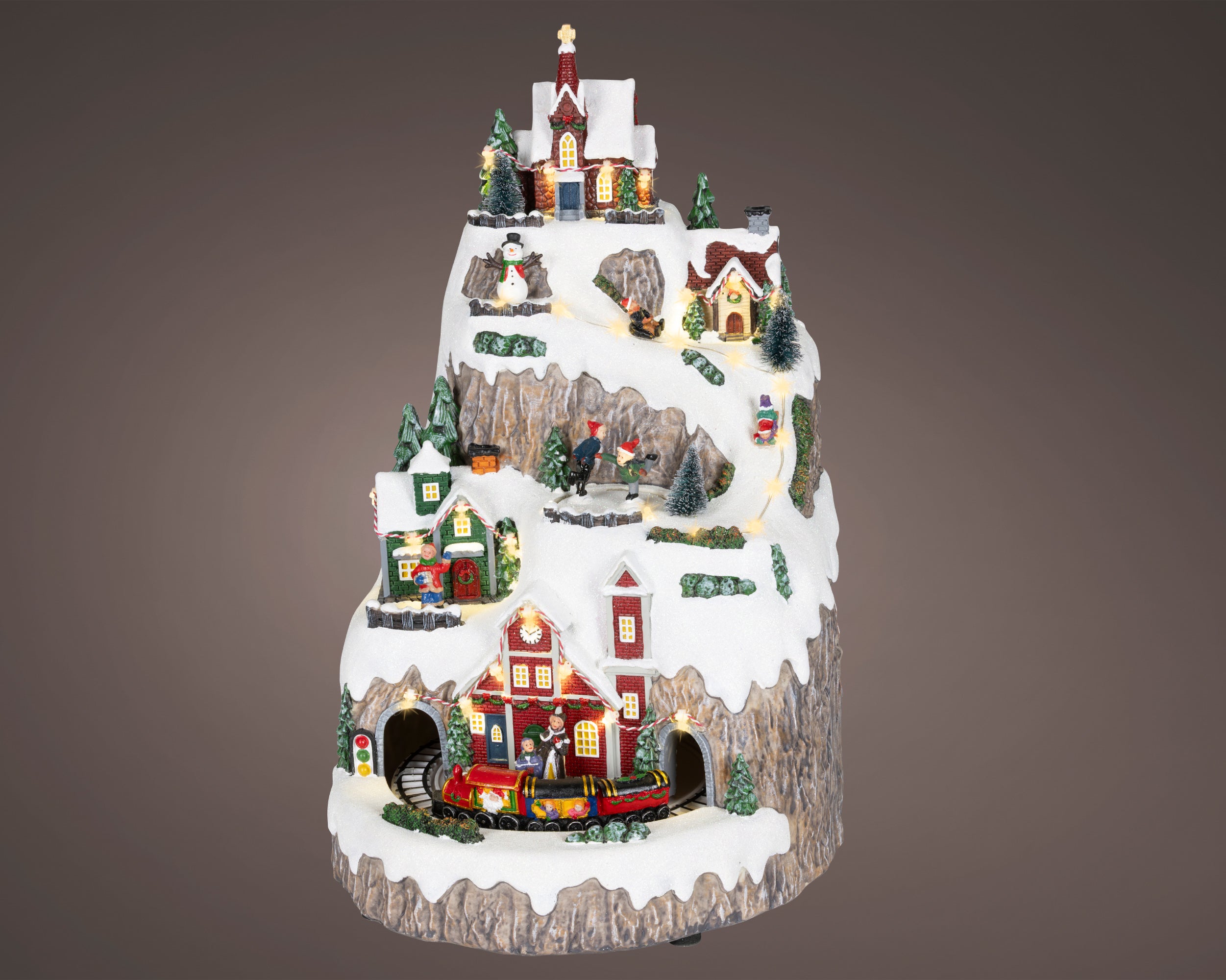 Kaemingk, Villaggio Innevato con Movimenti 29x26x41 cm, ambientazione natalizia Lemax multilivello con casette illuminate, chiesa, alberi innevati e trenino animato in movimento su binario - DeMatteis.it