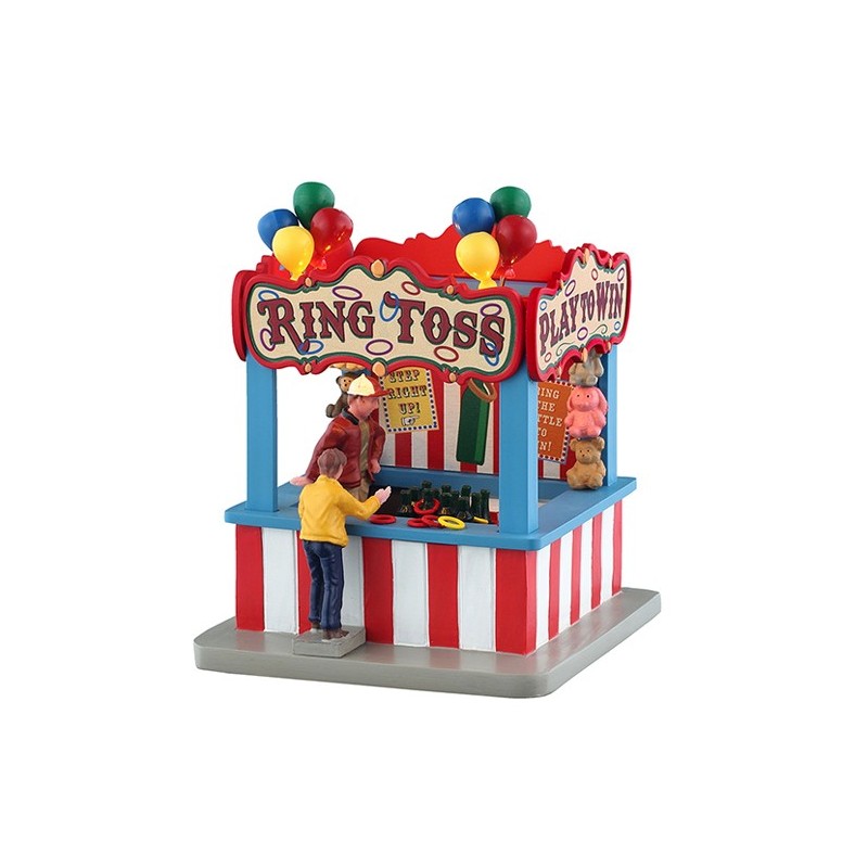 Ring Toss Game Lemax con bancarella a strisce rosse e bianche, bambino in giacca gialla che gioca, palloncini colorati e premi orsacchiotto per Villaggio Natale Lemax collezione Carnival Village | Dematteis.it