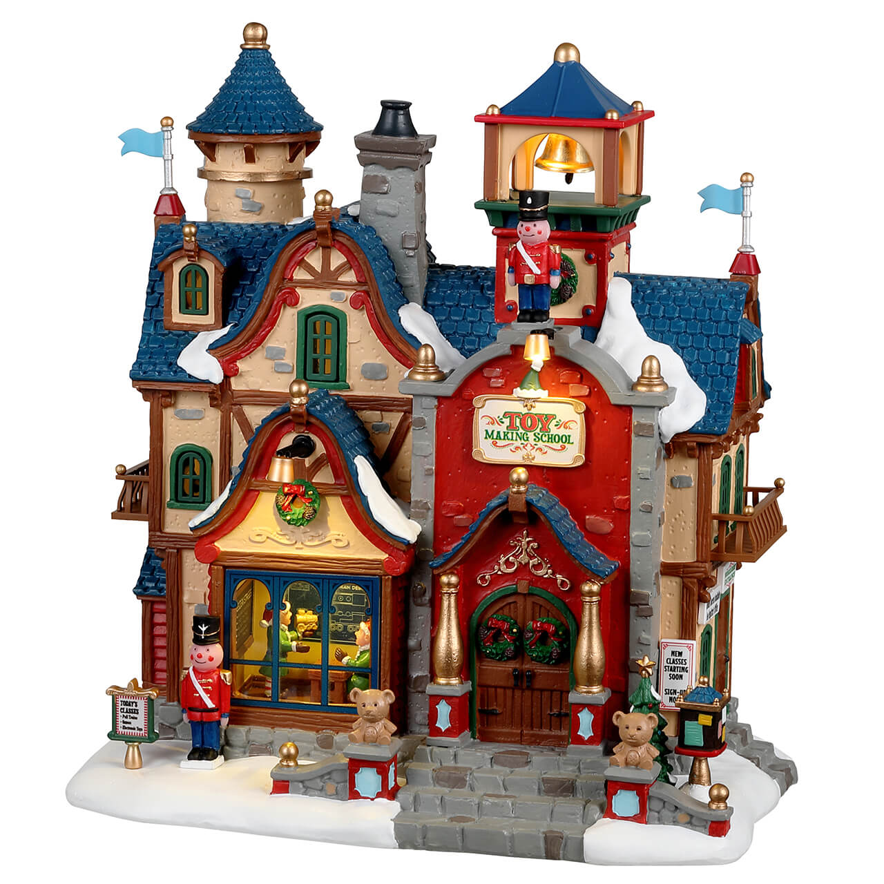 Toy Making School Lemax: edificio illuminato del Villaggio Lemax con tetti blu innevati, torri vittoriane e soldatini decorativi, dove gli elfi studiano l'arte della fabbricazione di giocattoli per Natale. | Dematteis.it