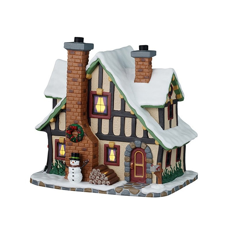 Winter Holiday Lodge Lemax con architettura Tudor illuminata, tetto innevato, pupazzo di neve e decorazioni natalizie per Villaggio Natale Lemax | Dematteis.it